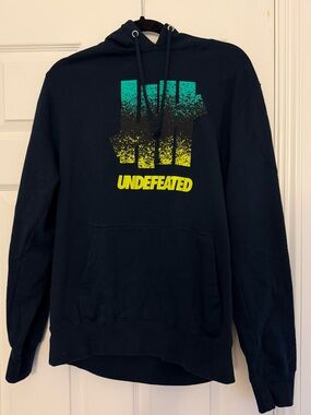 Undefeated Black Hoodie with Teal-to-Yellow Gradient Logo